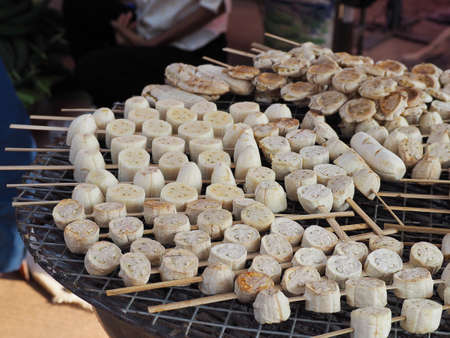 Grilling bananas for thai dessert on charcoal grill.の写真素材