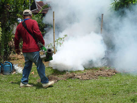 Men are working fogging to eliminate mosquitoes.の写真素材