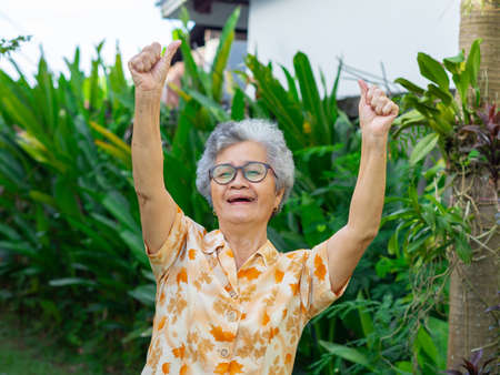 Portrait of happy senior woman showing success gesture.の写真素材