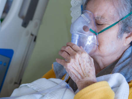 Close-up of elderly woman patients with lung disease, getting oxygen for treatment in the room at hospital. Space for text. Health care conceptの写真素材