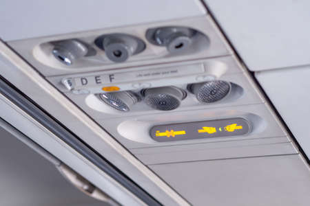 Symbol no smoking and fasten seat belt show on the seats overhead in airplane that be lighting for...