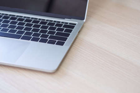 Close-up Of side view of the laptop is placed on the wooden desk in the office. There is space for text advertisingの写真素材