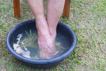 Close-up of spa foot with herbs water for relaxation treatment.の写真素材