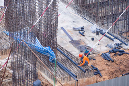 Worker is working to construct building in the construction area. Labor conceptの写真素材