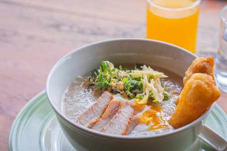 Asian rice porridge with Chinese donut or Chinese bread stick and boiled egg for breakfast. Concept...