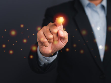 Businessman pressing a button on virtual screen. Man pointing on a futuristic interface.の写真素材