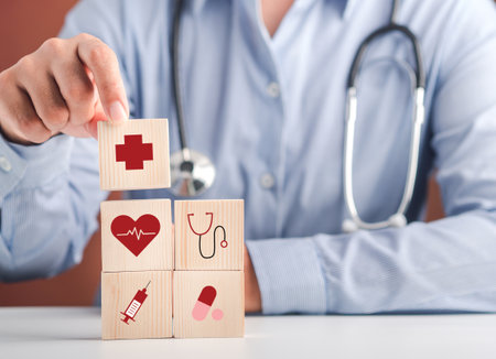 Hand of doctor arranging wood blocks with healthcare medical icons. Space for text. Health and medical concept.の写真素材
