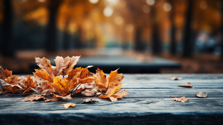 An empty wooden tabletop with orange leaves in autumn seasonal. Space for text. AI Generated.の素材
