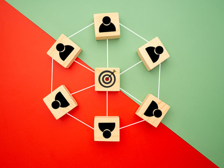 Focus on goal business. Network, teamwork, and unity concept. Top view of wooden blocks with human and goal icons on colorful background, Flat lay, space for text.の写真素材