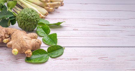 Top view of lemongrass, ginger, bergamot on wooden table. Thai herbal. Herbal, treatment, and healthcare concept.の写真素材