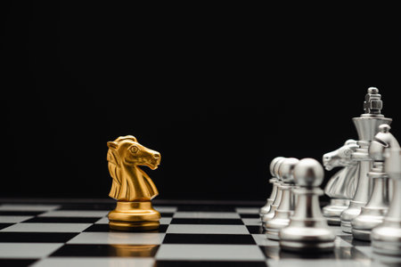 Chess pieces on board game planning and competition on black background. Business leadership and strategy conceptの写真素材