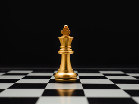 Chess piece on board game planning and competition on black background. Business leadership and strategy conceptの写真素材