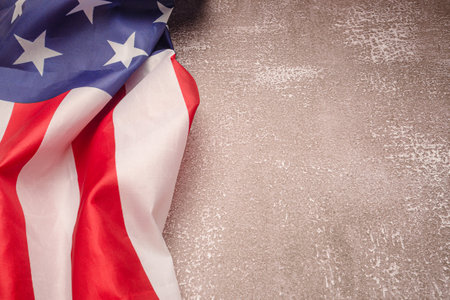 American flag on a cement background with copy space. Top view. Close-up photo