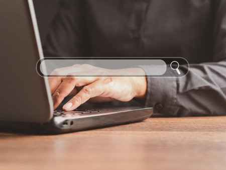 Search engine online concept. Close-up of hand a man using a laptop for searching information on a web browser. Technology and communicationの写真素材