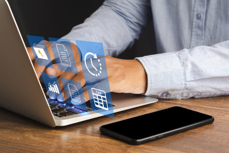 Businessman using a laptop to fill individual income tax online for tax payment. Tax day and calculation tax returnの写真素材