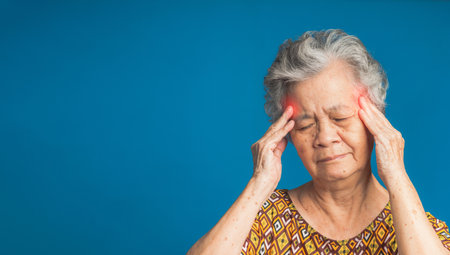 An elderly Asian woman who has a severe headache suffers from a stroke, brain attack, or migraines. Brain diseases problem cause chronic severe headaches. Aged people and healthcare conceptの写真素材