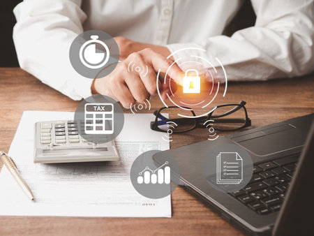 Tax day concept. Businessman using the laptop to fill in the income tax online return form for payment. Tax payment conceptual. Security network on virtual screenの写真素材