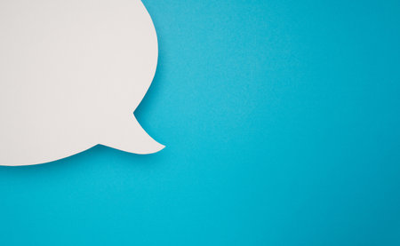 Blank white speech bubble part on a blue background. A speech bubble concept. Space for text. Top...