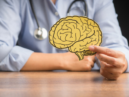 Doctor holding a brain shape made from yellow paper. Awareness of Alzheimer's, Parkinson's disease, dementia, stroke, seizure, or mental health. Neurology and Psychology careの写真素材