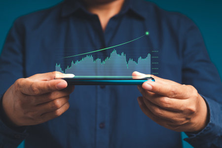 Hand holding of a mobile phone with digital increasing bar business graph growth. Data analytics...