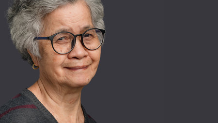 Portrait of a senior woman with short gray hair looking at the camera with a smile while standing on...