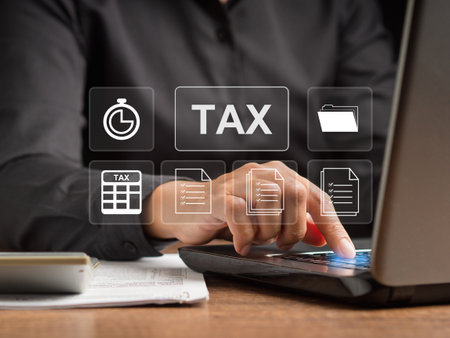 Tax payment and calculation tax return concept. Businessman using a laptop to complete Individual income tax return form online for tax payment. Taxes paid by individuals and corporationsの写真素材