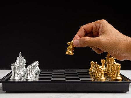 Businessman playing with chess game. Business strategy ideas and investment. Close-up photoの写真素材