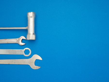 Work tools on a blue background. A screwdriver and spanner. Top view. Space for textの写真素材