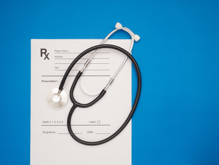 Top view of a stethoscope over the medical prescription sheet on a blue background. Space for text. Medical and healthcare conceptの写真素材