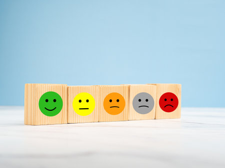 Customer feedback. Wooden cubes with the face icon give satisfaction to the service. Service...