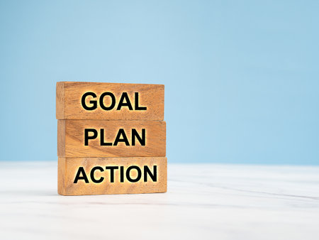 Business plan and strategy concept. Wooden blocks with the letters Goal, Plan, and Action over a marble floor with a blue background. Space for textの写真素材