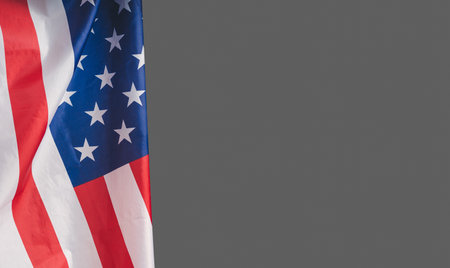 Close-up of the American flag on a gray background. Space for text. Close-up photoの写真素材