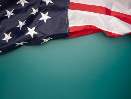 Top view of the American flag on a green background with copy space for text. Top view. Close-up photoの写真素材