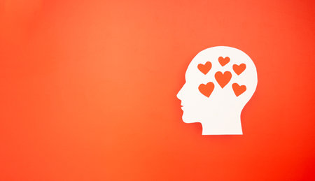Top view of a white head with red hearts on a red background. Awareness of Alzheimer's, Parkinson's,...