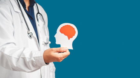 Midsection of doctor in uniform holding a white head with a red brain symbol made from paper while...
