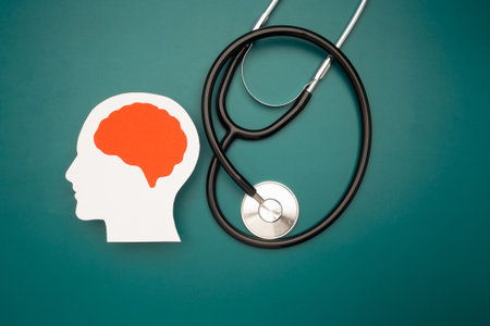 A brain shape made from paper and a stethoscope on a green background. Artificial intelligence, Innovative technology in science and medicine conceptの写真素材