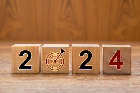 Business planning to 2024. Wooden cubes with the letters 2024 and goal. New year's eve and change the year 2023 to 2024の写真素材