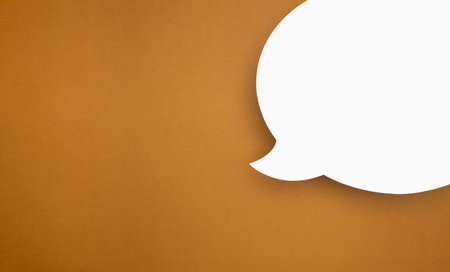 A blank white speech bubble part over a brown background. A speech bubble concept. Space for text....