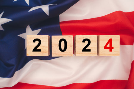 Top view of wooden cubes with letters 2024 over the American flag background. United States presidential election. Politics and voting conceptualの写真素材