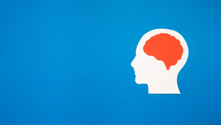 A brain shape made from paper on a blue background. Awareness of Alzheimer's, Parkinson's, dementia, stroke, seizure, or mental health. Neurology and Psychology careの写真素材
