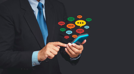 Social network and live chat chatting concept. Close-up of hands using mobile phone with colorful...