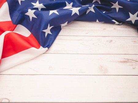 Top view of the American flag on a wooden table. Space for text. Close-up photoの写真素材