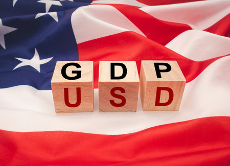 GDP or gross domestic with wooden cubes or blocks on the American flag background. Business and...