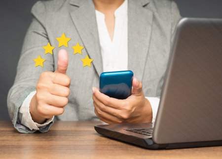 Businesswoman hand with thumb up for best excellent services satisfaction client giving a five-star...