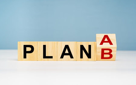 Business planning strategy concept. Wooden cubes with words PLAN A change to PLAN B on a table with...