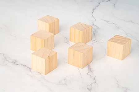 Top view of blank six wooden cubes on a marble background. Space for textの写真素材