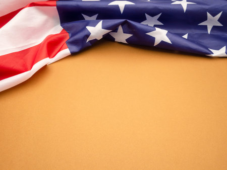 Top view of the American flag on a brown background. Space for text. Close-up photoの写真素材