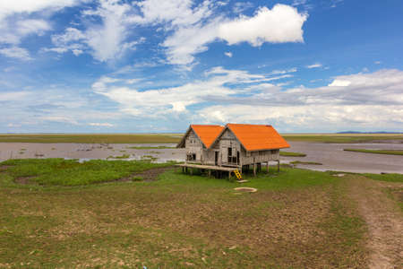 Countryside perspective vintage of local traditional old moldy hut in lake against with beautiful blue sky at talaynoi, Phatthalung Province, South of Thailand.のeditorial素材