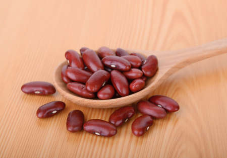 red bean in wood spoon on wood tableの写真素材