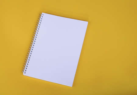 Blank white notebook on yellow backgroundの写真素材